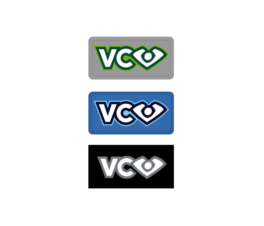 Three VC Ultimate labels in horizontal order. The grey rubber label indicates the apparel is made in Toronto, Canada. The blue rubber label indicates apparel made in Poland, Europe. The flat, black woven label indicates apparel made in China.